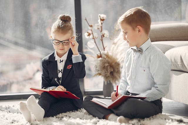 smiling-business-kids-with-daily-planners-at-home